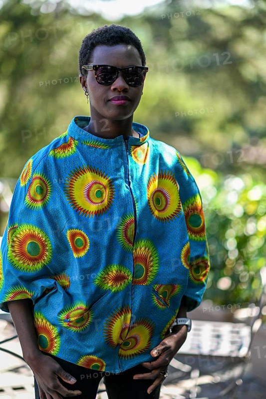 Young adult afro hair diverse black model pose outdoors in african print attire wear sunglasses