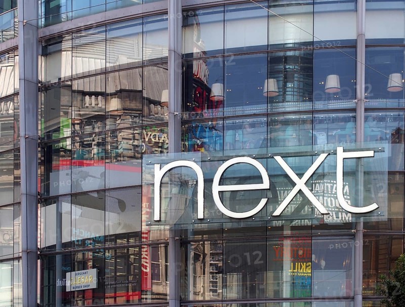 Manchester, united kingdom, 24 march 2022: sign on the front of the next clothing store in exchange square in manchester city centre