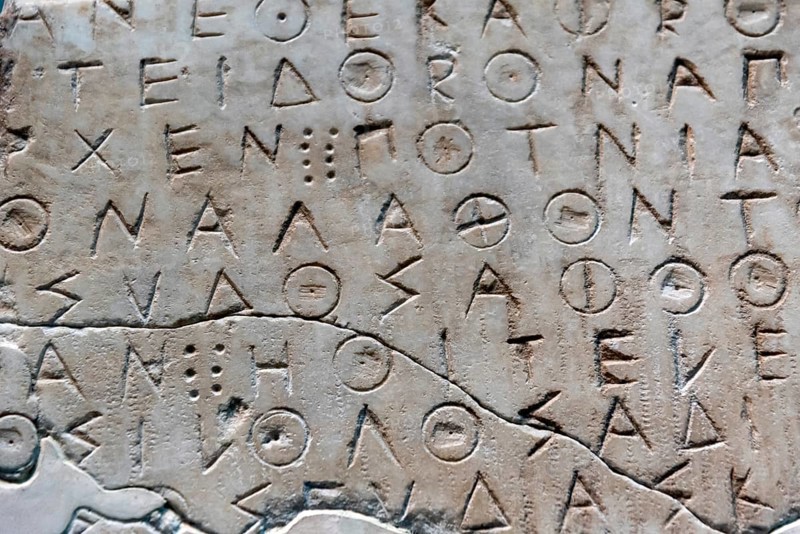 Ancient greek letters in stone abstract background