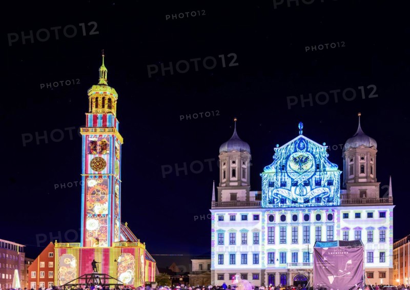 AUGSBURG, GERMANY - OCTOBER 24: Illuminated historic buildings (town hall and perlach tower) at the festival of lights in Augsburg, Germany on October 24, 2021