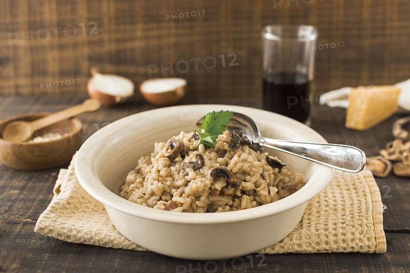 Close up mushroom risotto white bowl with spoon napkin table. Resolution and high quality beautiful photo