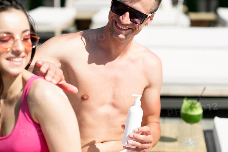 Cute couple beach with sunscreen