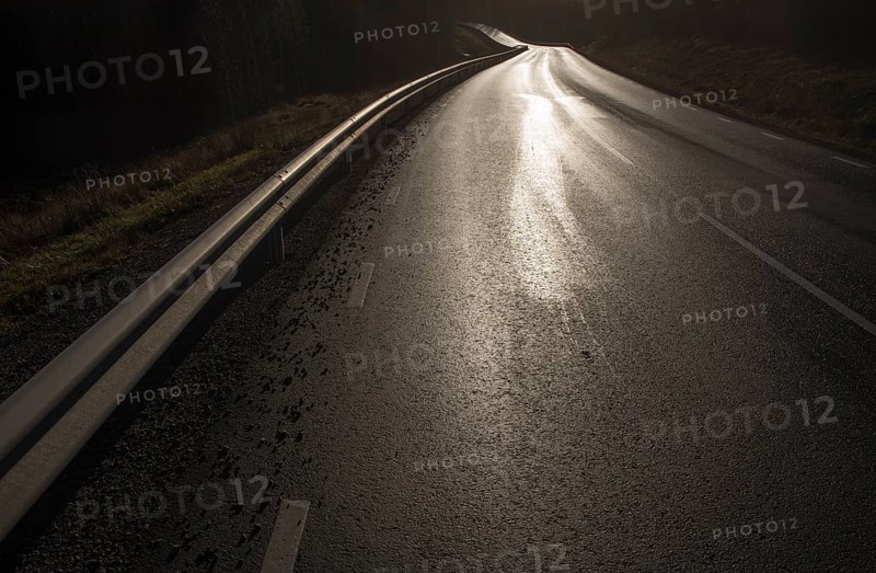 Country road, wet and shiny against the light, black and white, road 175 near Nysäter, Värmland, Sweden, Europe