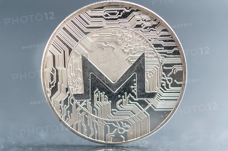 Monero. Crypto currency silver coin, Macro shot of Iota coin isolated on background, cut out