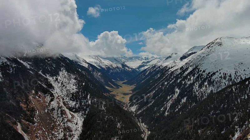 Aerial view of mountains and Krimml Waterfalls on sunny day. High Tauern National Park, Austrian Alps, Austria, Europe