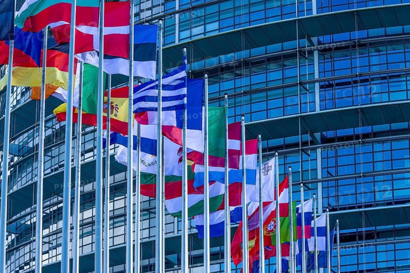 EU flags on poles in front of the Glass Fasadz building and the entrance to the European Parliament, European Parliament, Strasbourg, Alsace, Département Bas-Rhin, France, Europe