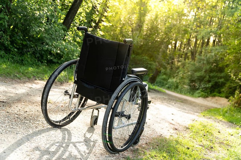 Photo of empty wheelchair parked in park, health care concept