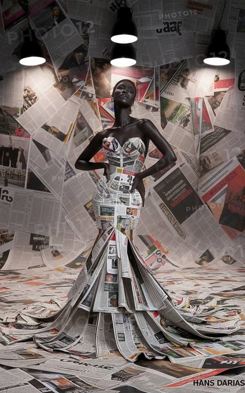 Artistically lit female model wearing an avant-garde dress made of newspapers, AI generated