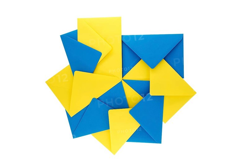 Collection of blue and yellow paper envelopes arranged against a white background, arrangement gives the appearance of a three-dimensional, exploding geometry that adds a sense of depth and vibrancy