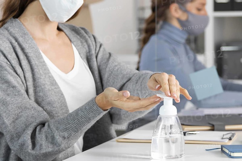 Close up woman using disinfectant. High resolution photo
