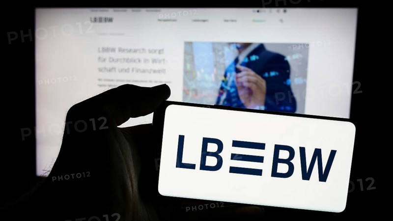 Stuttgart, Germany, 07-15-2024: Person holding mobile phone with logo of German company Landesbank Baden-Wuerttemberg (LBBW) in front of business web page. Focus on phone display, Europe