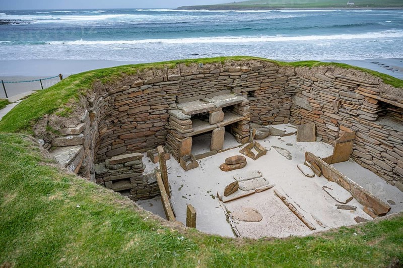 Skara Brae prehistoric village at Orkney Island, wide angle shot, sea in the background, Scotland, United Kingdom, Europe