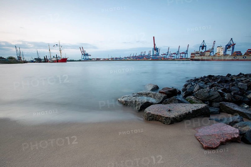 Elbe beach with container terminal and ships in the background in Hamburg
