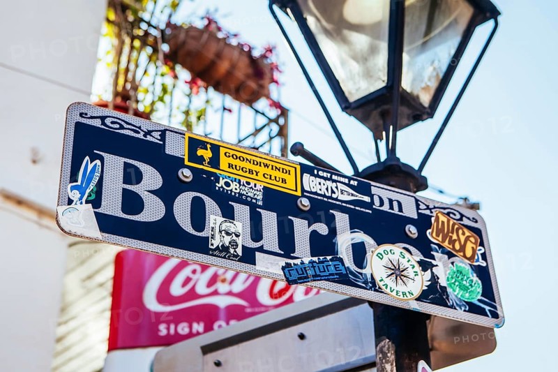 New Orleans, USA, January 24 2013: Bourbon St signage covered in tourism stickers in New Orleans, Louisiana, USA, North America
