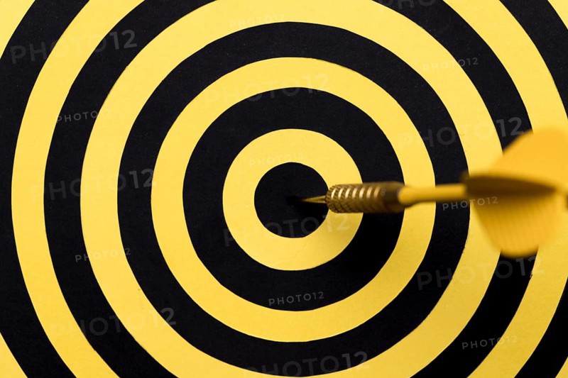 Close up dartboard center with arrow