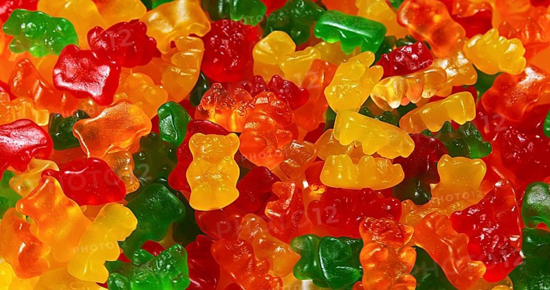 Gold Bears or Gummy Bears falling against White Background