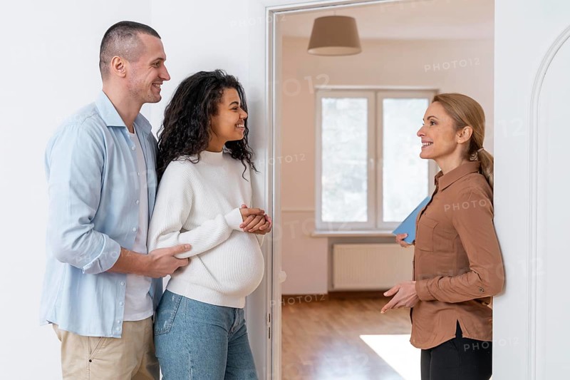 Side view realtor inviting couple see new house