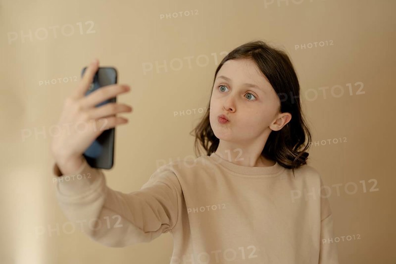 Girl, 10, takes a selfie with mobile phone