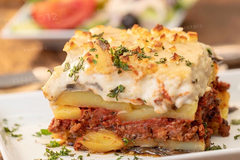 Portion of greek moussaka on wood