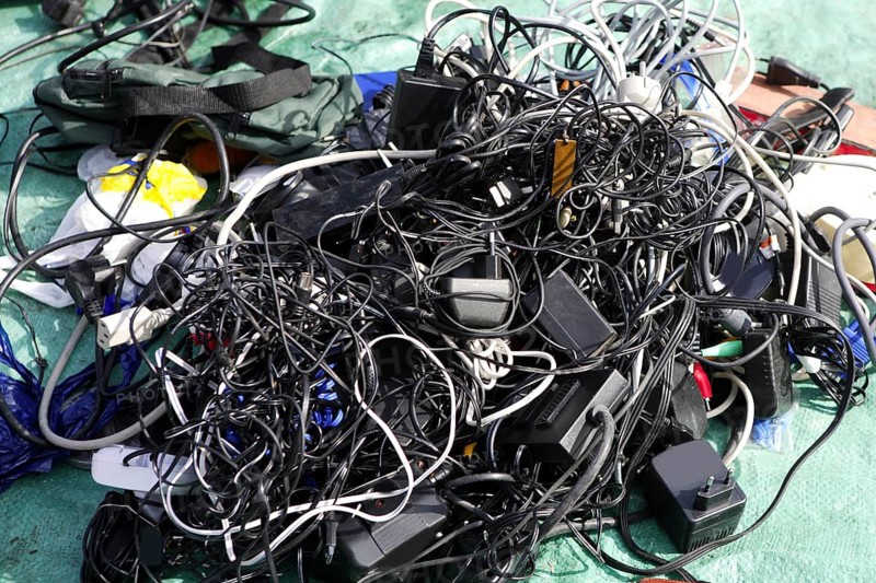 Battery charger and wires mess in second hand market tech trash