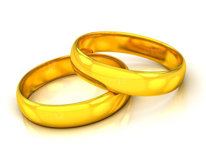 Golden wedding rings on a white beckground