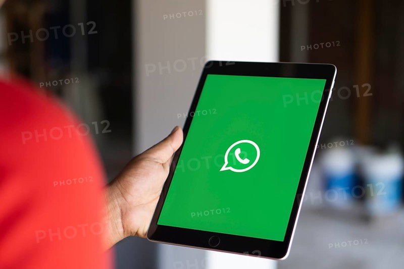 Man holding a cellphone with WhatsApp on the screen.Dhaka, Bangladesh- 09 September 2024.