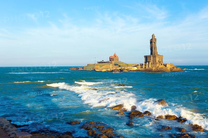 Vivekananda Rock is home to a memorial and neighboring island Thiruvalluvar Statue off the coast of Kanyakumari, Tamil Nadu, India on a blue sky day. Horizontal