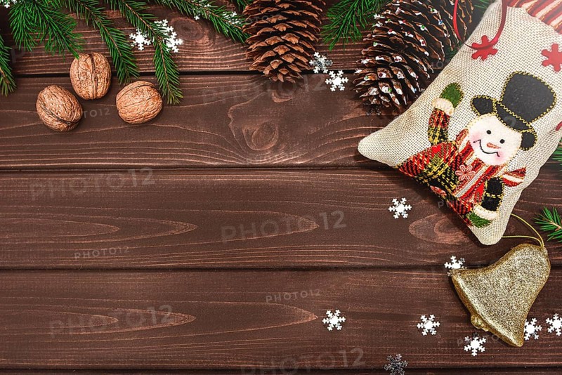Christmas background Fir branches, cones and nuts on a wooden table. Space for text, View from above. Christmas atmosphere