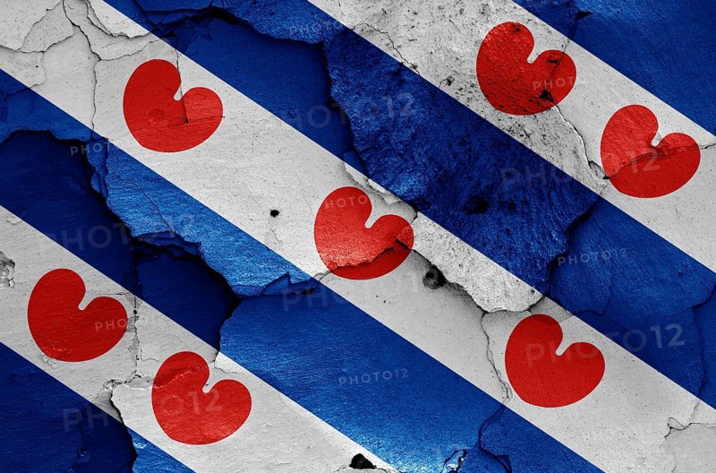 Flag of Friesland painted on cracked wall