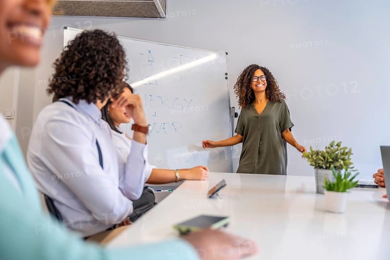 Woman smiling and transmitting good vibes in a meeting in a coworking