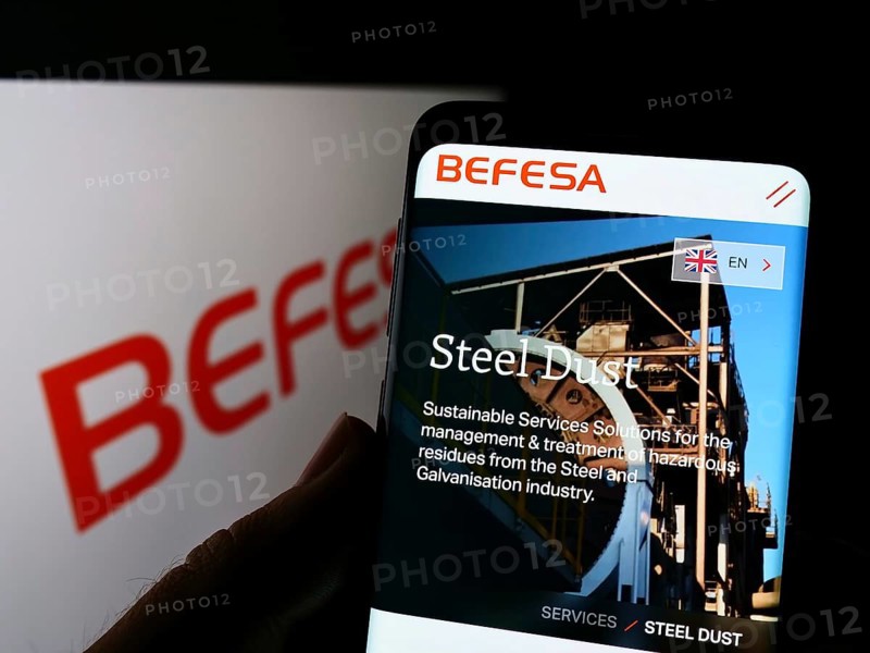 Stuttgart, Germany, 05-21-2022: Person holding cellphone with webpage of recycling company Befesa SA on screen in front of business logo. Focus on center of phone display, Europe