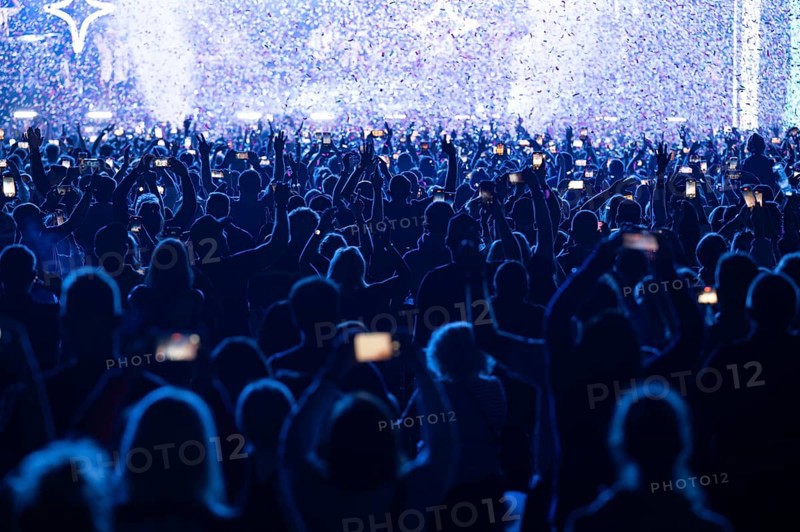 Crowd of people in front of the stage during the concert.