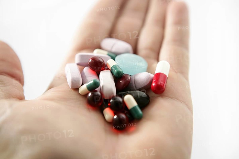 Pills over white, health or suicide, metaphor
