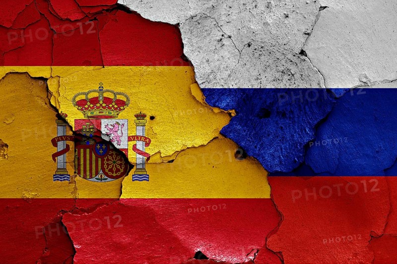 Flags of Spain and Russia painted on cracked wall