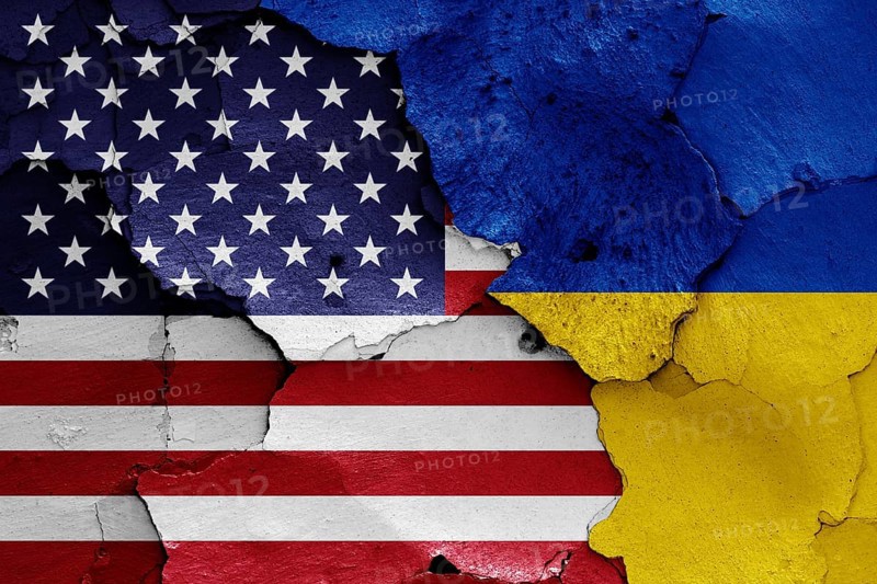 Flags of USA and Ukraine painted on cracked wall