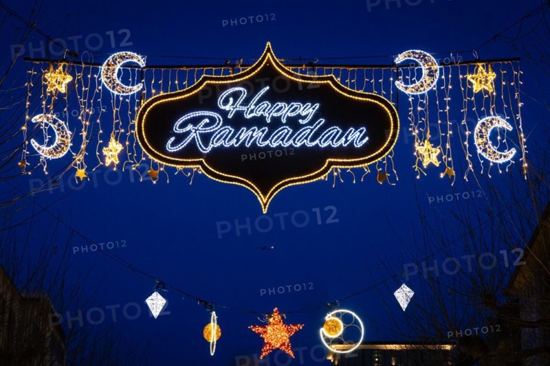 The illuminated lettering Happy Ramadan shines on the evening of 10 March 2024 as part of a light installation stretched across Große Bockenheimer Straße (Fressgass) in Frankfurt am Main. Ramadan is the month of fasting for Muslims and the ninth month of the Islamic lunar calendar. According to Islamic belief, the Koran was revealed during this month. In 2024, Ramadan begins on the evening of 10 March and ends on the evening of 9 April, Große Bockenheimer Straße, Frankfurt am Main, Hesse, Germany, Europe