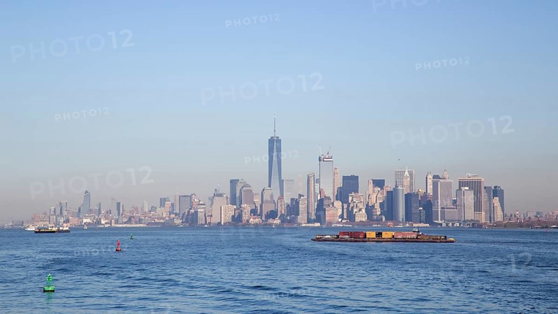 New York, United States of America, November 18, 2016: A container ship in front of the Lower Manhattan skyline