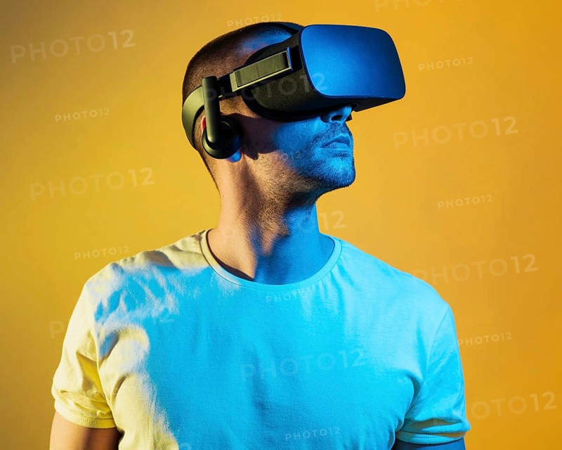 Medium shot man wearing virtual reality gadget