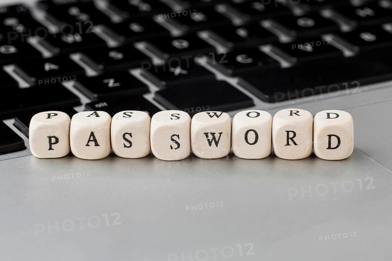 High angle defocused wooden cubes with password laptop
