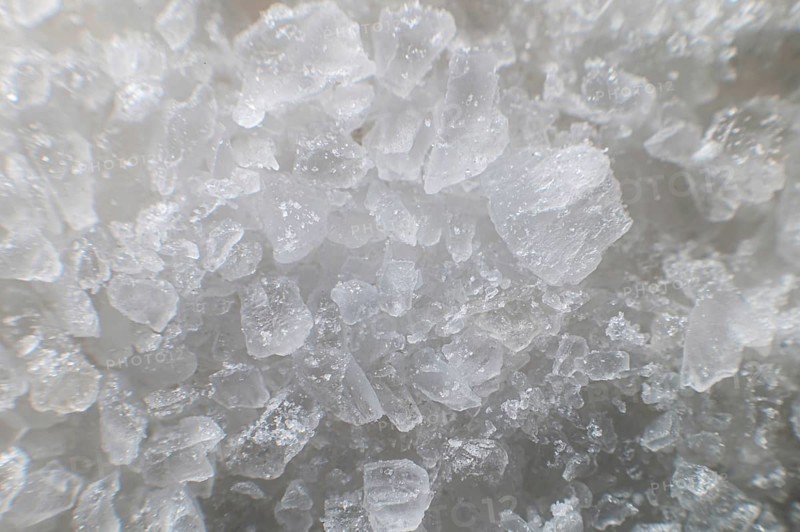 Macro view of crystals of table salt. Taste useful additive saline solutions background in shallow depth of field. Close-up