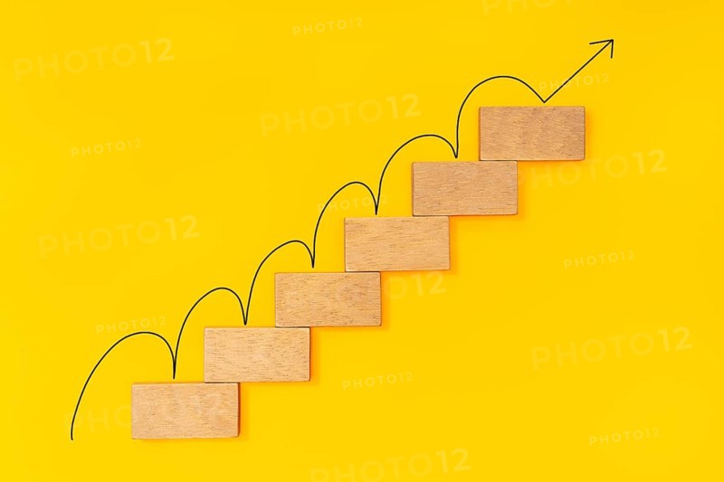 Rising arrow on wooden staircase. Growth concept, Ladder of success in business