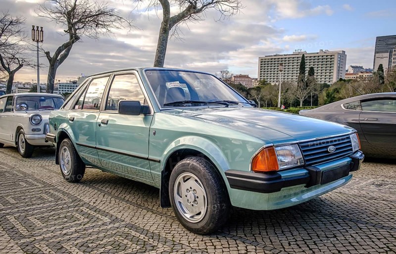Lisbon, Portugal, Jan 20, 2024: A classic light green Ford Escort 3rd generation car known as Erika, 5 door hatchback, parked on a cobblestone road in a city, Europe
