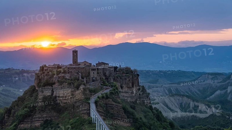 The mountain village of Civita di Bagnoregio in hilly landscape at sunrise, Civita di Bagnoregio, Lazio, Italy, Europe