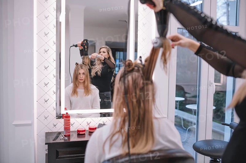 Hairstylist using brush dryer