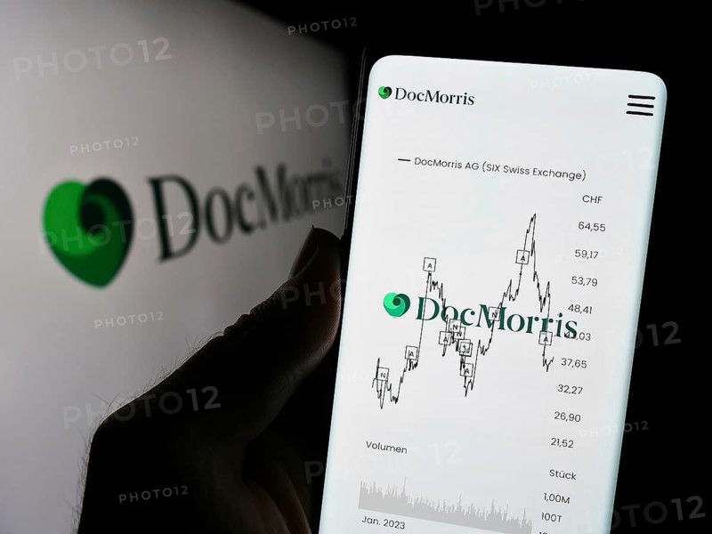 Stuttgart, Germany, 11-08-2023: Person holding cellphone with webpage of Swiss online pharmacy company DocMorris AG in front of logo. Focus on center of phone display, Europe