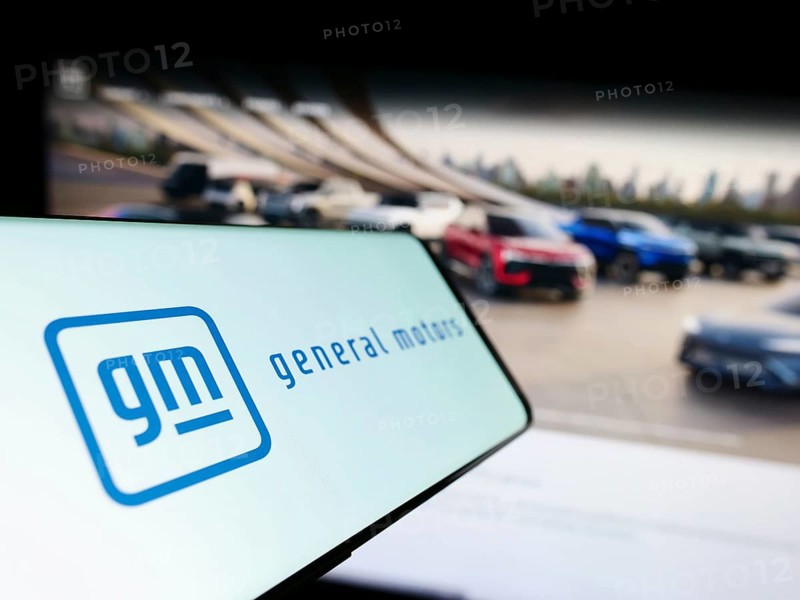 Stuttgart, Germany, 07-01-2023: Cellphone with logo of US car manufacturer General Motors Company (GM) on screen in front of website. Focus on center-left of phone display, Europe