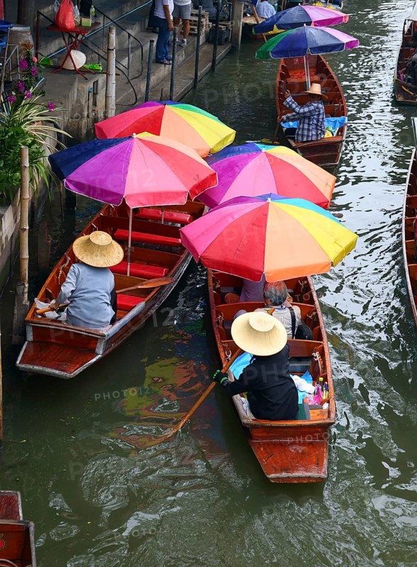 Boats with umbrella on floating market Damnoen Saduak in Bangkok, Thailand, Asia