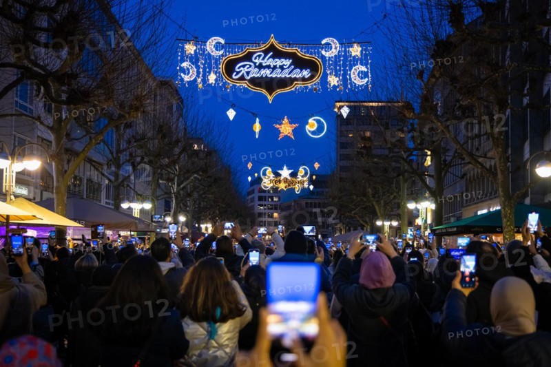 The illuminated lettering Happy Ramadan shines on the evening of 10 March 2024 as part of a light installation stretched across Große Bockenheimer Straße (Fressgass) in Frankfurt am Main. Ramadan is the month of fasting for Muslims and the ninth month of the Islamic lunar calendar. According to Islamic belief, the Koran was revealed during this month. In 2024, Ramadan begins on the evening of 10 March and ends on the evening of 9 April, Große Bockenheimer Straße, Frankfurt am Main, Hesse, Germany, Europe