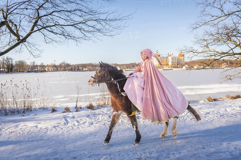 This year, the most popular fairytale film of all time is celebrating a special anniversary. At Moritzburg Castle, one of the film's locations, the exhibition on the cult film Three Hazelnuts for Cinderella is opening for the twelfth time - with an anniversary-worthy supporting programme and special exhibition. Model Tamara Kretschmer once again slipped into the coveted role of the legendary Cinderella with the ball gown. Here she rides the legendary film horse Catano, Moritzburg, Saxony, Germany, Europe