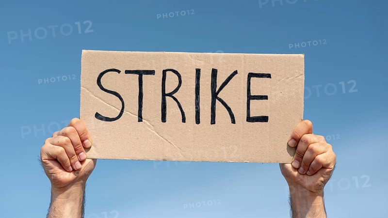 Protester holding board with strike